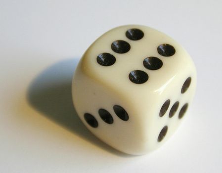 a white bone playing dice showing the number 6