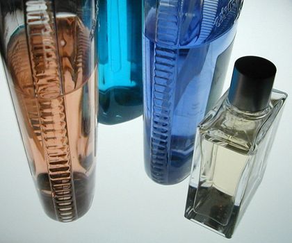 colorful bottles of after shave and other bathroom lotions