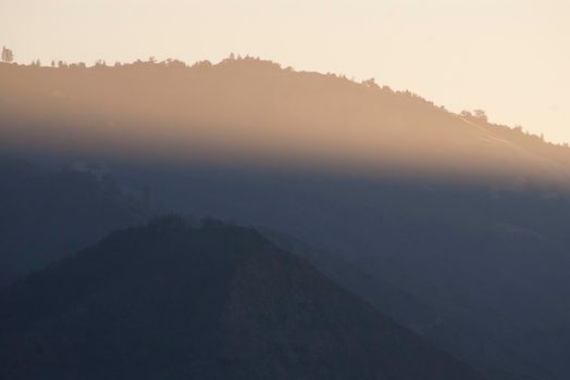 a beam of sunlight across the bigsur cliff landscape