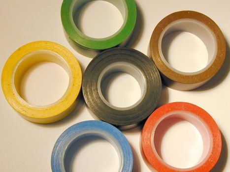 Set of various colorful insulating tapes arranged as a flower, viewed in close-up