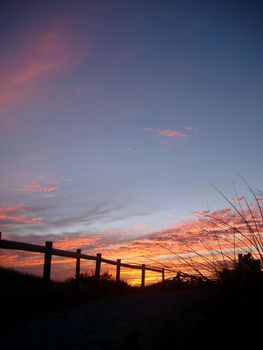 beautiful sunset and silhouetted fence, in western australia