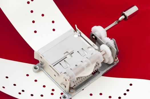 a punched paper tape playing music box