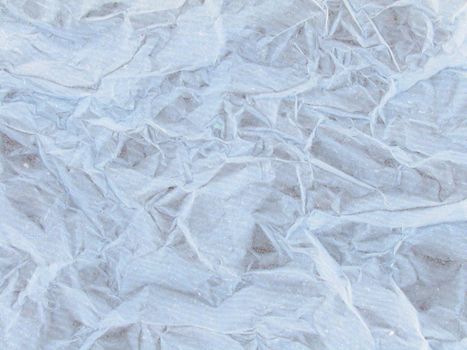 Detailed background of wrinkled paper in white neutral color with rough texture with copy space