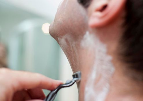 a man shaving with a blade razor