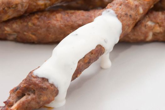 Spicy kofta kebabs made from minced lamb, spices and herbs and served with a sauce
