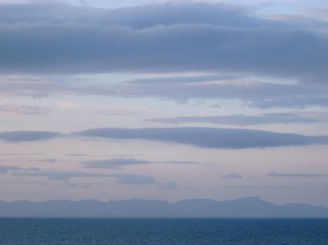 after sunset looking across the water at a distant landmass