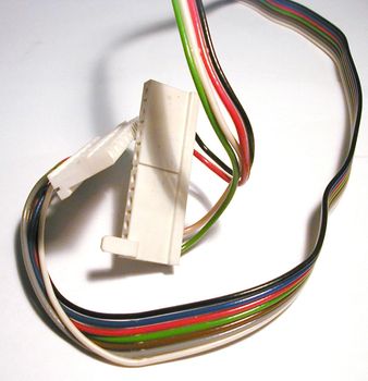 Power cord with multicolored wires disconnected from white plug