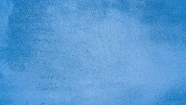 Blue abstract background..Beautiful blue textured plaster on the wall..Background from blue stucco..