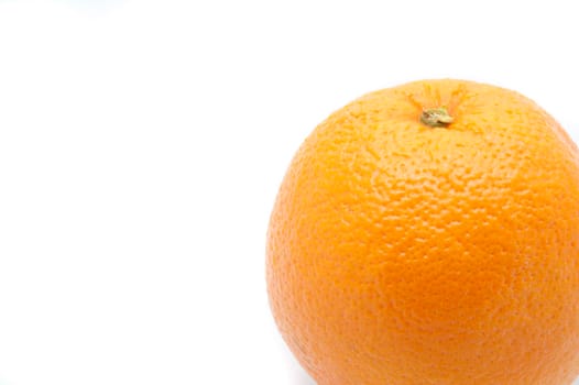 Close up texture of a whole fresh orange on a white background with copyspace
