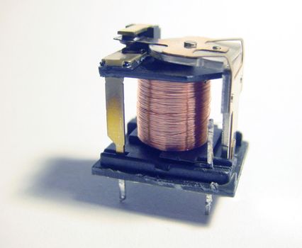 inside of an electromechanical relay switch showing coil winding and contacts