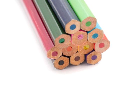 A closeup of the blunt end of coloured pencils on a white background