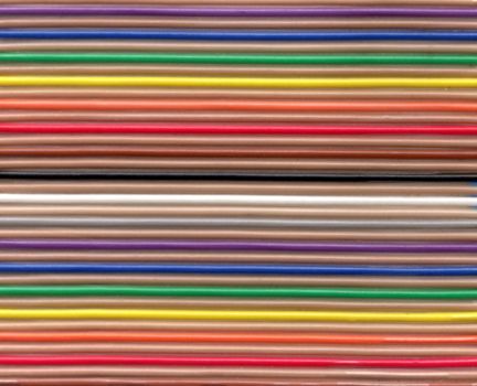 Unique background composed of colorful electronic cables placed in straight lines