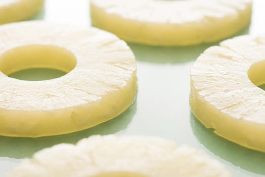Pineapple pieces cut in slices in close-up