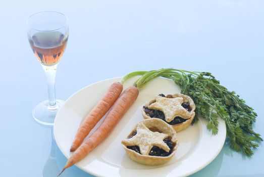a plate of christmas mince pies for santa and carrots of rudolph