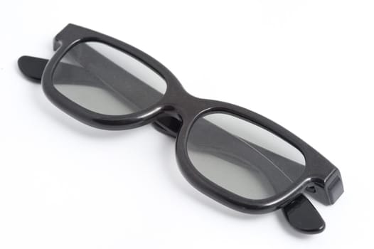 A pair of polarizing 3D movie spectacles on a white background