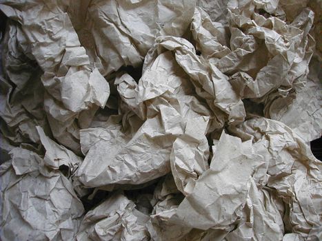 Background texture of crumpled packing paper used to wad and protect items in transit in a full frame overhead view