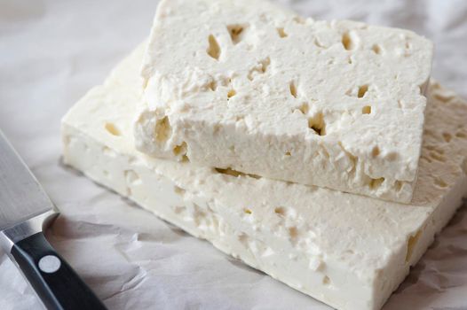 Closeup view of two slabs of feta goats milk cheese for use as a delicious salad ingredient or in cooking