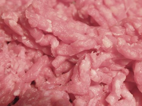 Closeup background texture of raw mince meat in a food and catering concept
