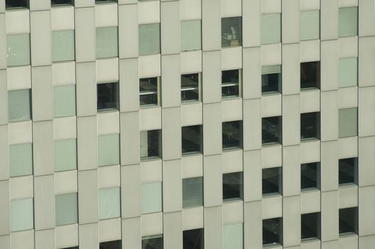 Facade of a modern urban office block with multiple windows, slightly angled