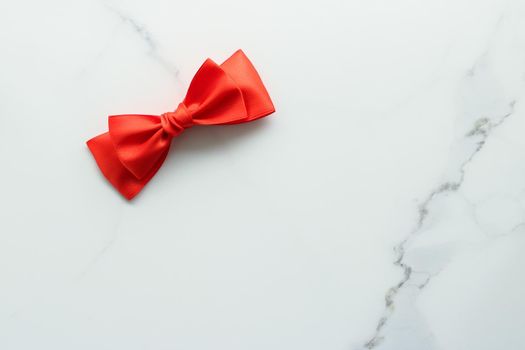 Holiday decor, feminine design and flatlay concept - Red silk ribbon on marble, top view