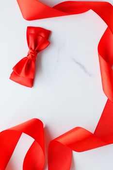 Holiday decor, feminine design and flatlay concept - Red silk ribbon on marble, top view