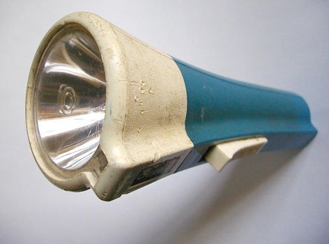Still Life of Old Flashlight Torch with Blue Handle, Unlit on White Background
