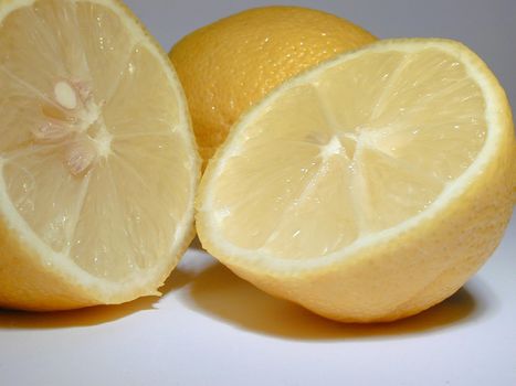 Halved fresh juicy tangy lemon rich in vitamin c used as a garnish, salad dressing and aromatic acidic cooking ingredient