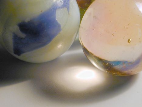 two traditional glass and stone marbles