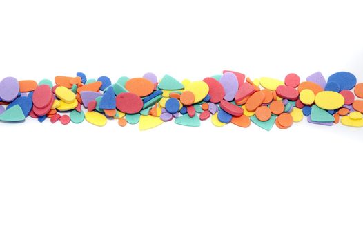 Colored shapes divider on white with a variety of different multicolored forms arranged in a row dividing the background into thirds with copy space
