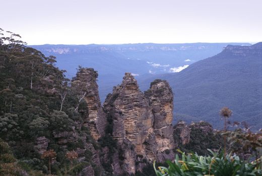 Scenic landscape view from a viewing point of the Three sisters rock formation, NSW, Australia overlooking distant valleys veiled in mist or haze