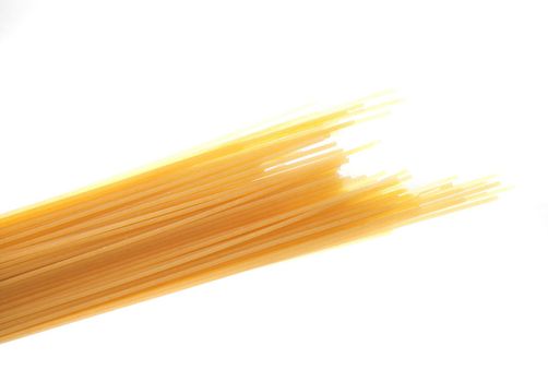 Bundle of uncooked dried Italian spaghetti pasta made from durum wheat dough as an ingredient in Mediterranean cuisine isolated on white