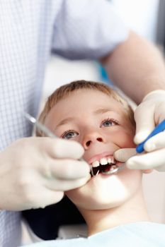 Dental treatment of boy. High angle view of cute boy going under dental treatment in clinic