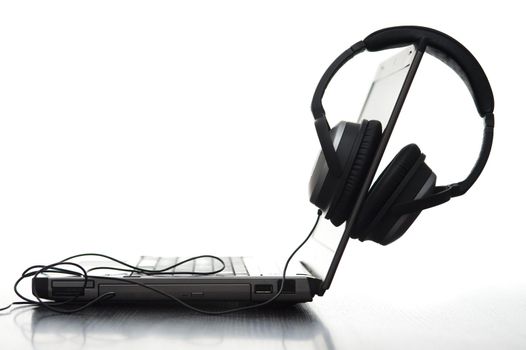 sideview of a laptop computer and hifi headphones