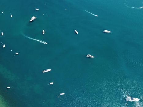 Aerial boat race. Luxury cruise trip. View from above of white boat on deep blue water. Aerial view of rich yacht sailing sea. Motor boat racing wave. Summer journey on luxury ship