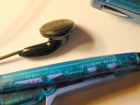Clip remote controls for personal audio player with volume buttons and one black plastic earbud detail image