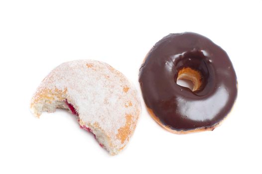 Freshly baked fried chocolate and jam doughnuts on a white background with the jam doughnut broken open to show the filling