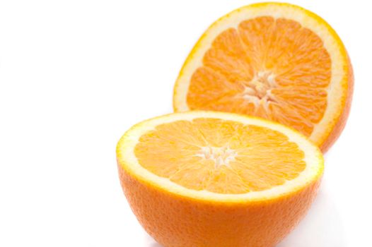 Close up view of a halved fresh sweet juicy orange on white with copyspace