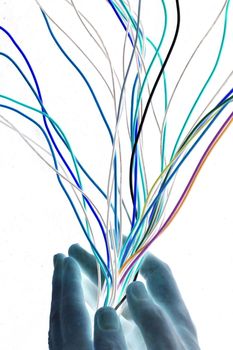 Artistic abstract with multicoloured electrical wires beign streamlined by cupped hands