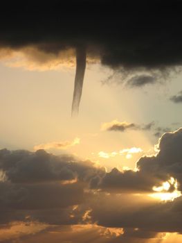 A cold air funnel cloud, like a mini tornado but is not in contact with the ground