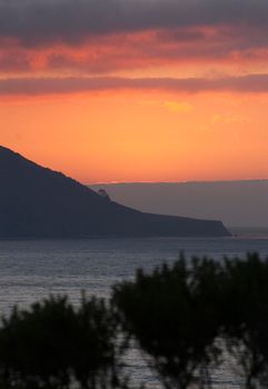 glowing orange sunset over california's spectacular big sur coastline
