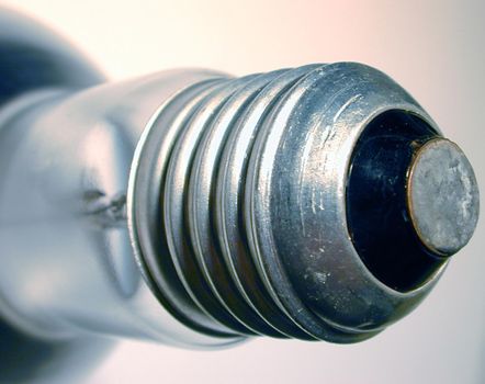 Close up on an Edison screw mount on a globe or light bulb with focus to the threads in a power and energy concept
