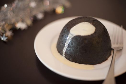 christmas plumb pudding dessert served with brandy custard