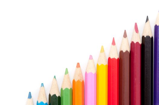 Stairs of colorful crayons isolated on white background