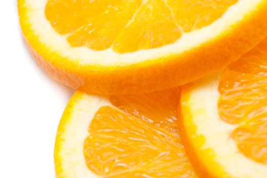 Close-up of three slices of a fresh tasty juicy orange, source of vitamin C, on white background