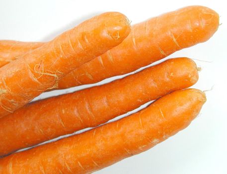 Close up view of a bunch of fresh raw carrots rich in carotene over a white background
