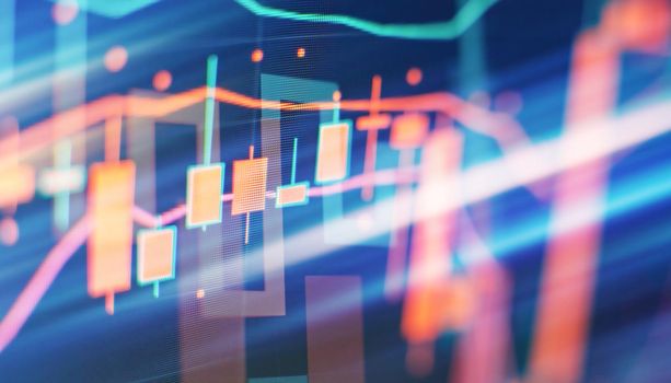 Charts of financial instruments with various type of indicators including volume analysis for professional technical analysis on the monitor of a computer.