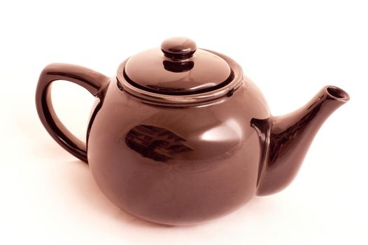 Close-up of a warm copper-colored basic teapot for everyday use, on white
