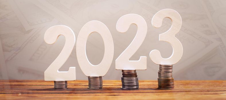 2023 on the stack of coins. tax payment, investment, and banking concept. 2023 new year saving money and financial planning concept