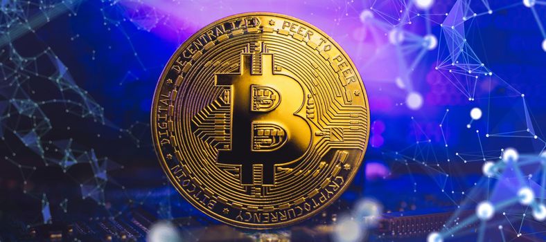 Bitcoins - the new modern currency for bitcoin payments ,  Golden Bitcoin Cryptocurrency on computer circuit board.