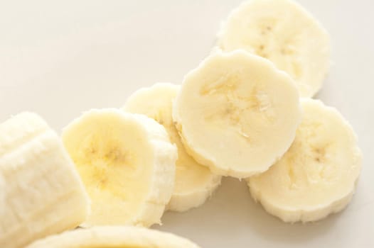 Close-up of chopped banana on white table